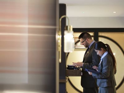 Team members working on computers at front desk