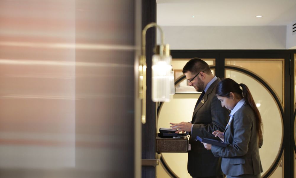 Team members working on computers at front desk