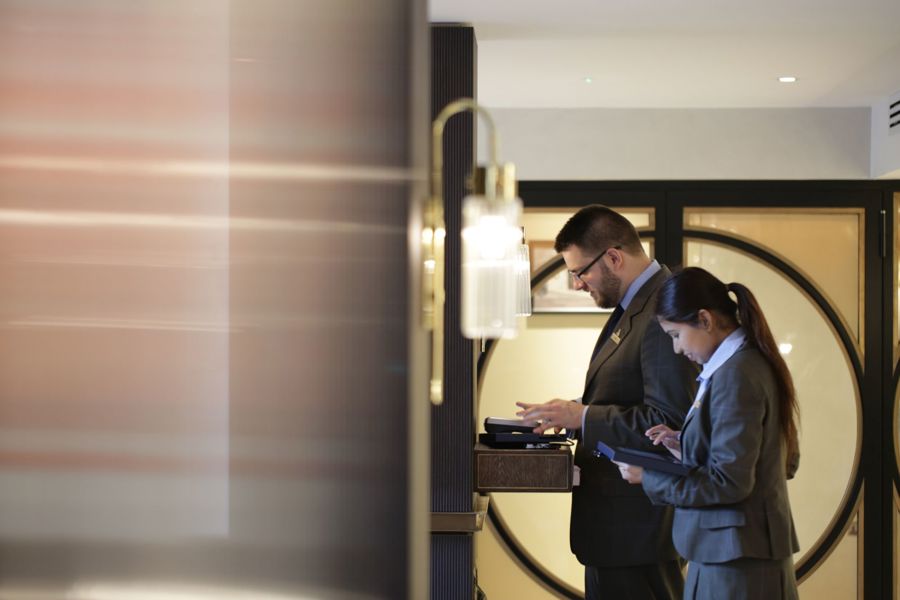 Team members working on computers at front desk