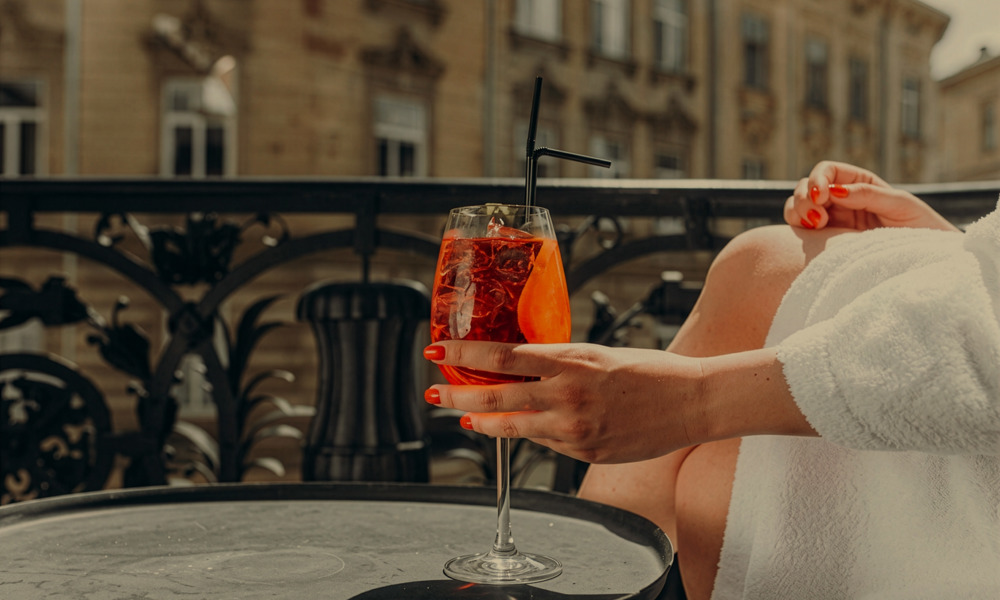 Woman drinking cocktail on terrace