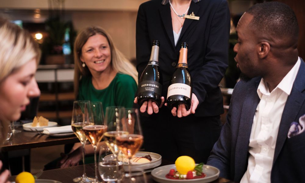 bottles of wine being shown to guests