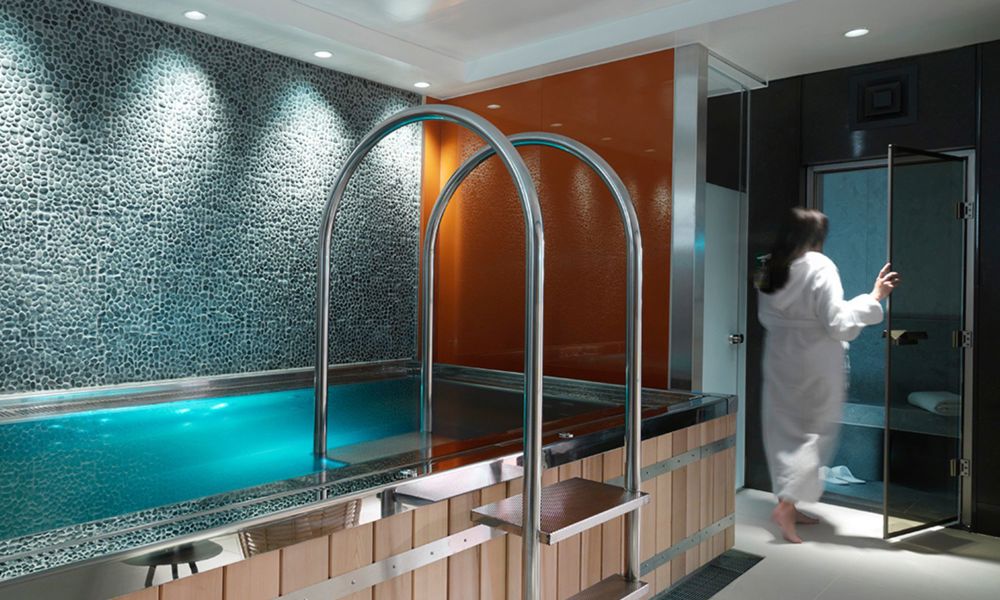 woman entering steam room in a spa with hot tub