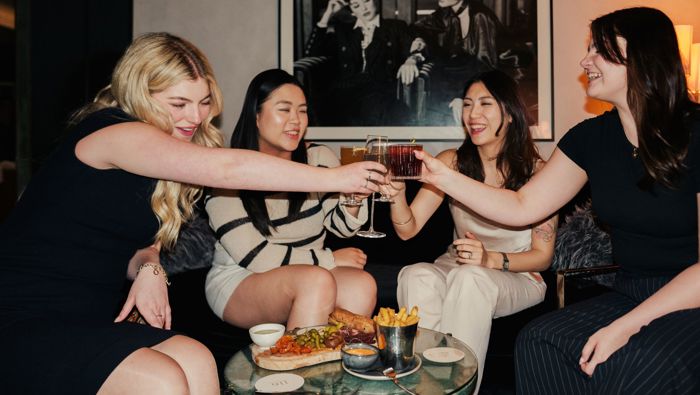 Group of girls clinking glasses