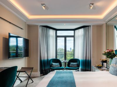 Hotel bedroom with chairs in a bay window