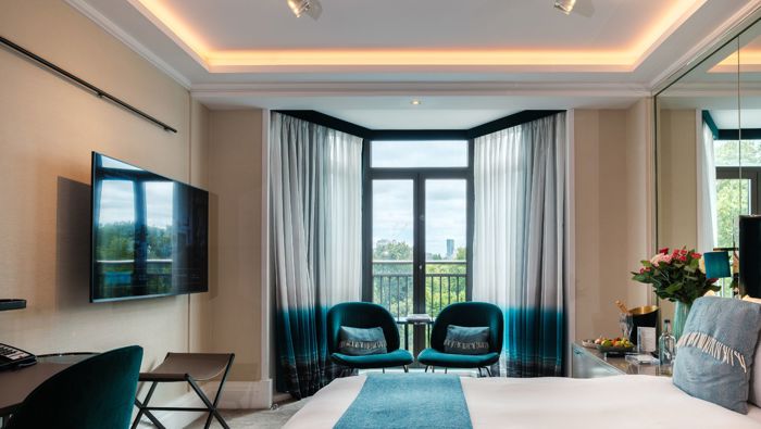 Hotel bedroom with chairs in a bay window