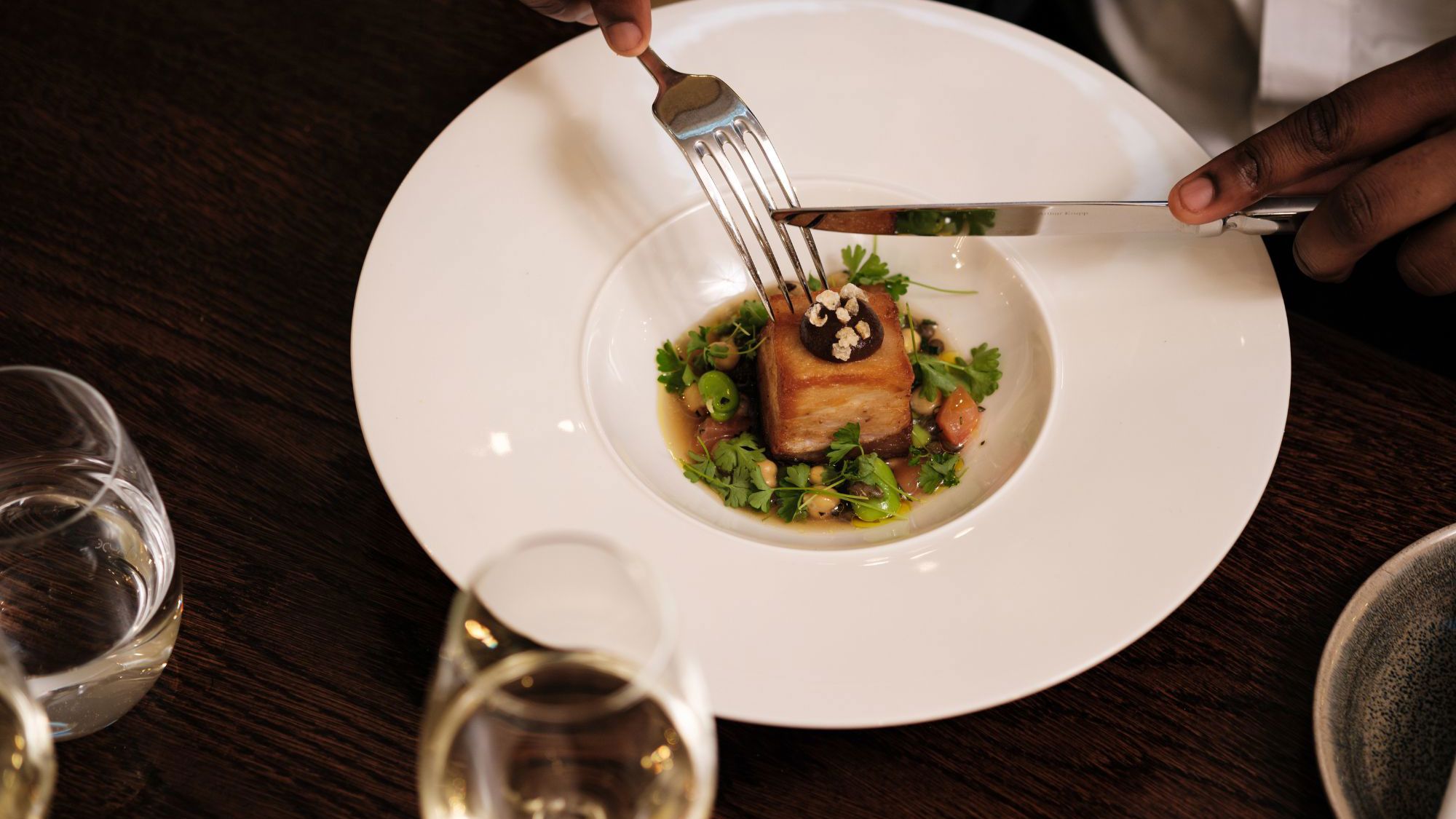 man eating from white plate