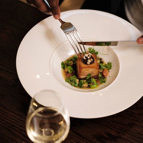 man eating from white plate