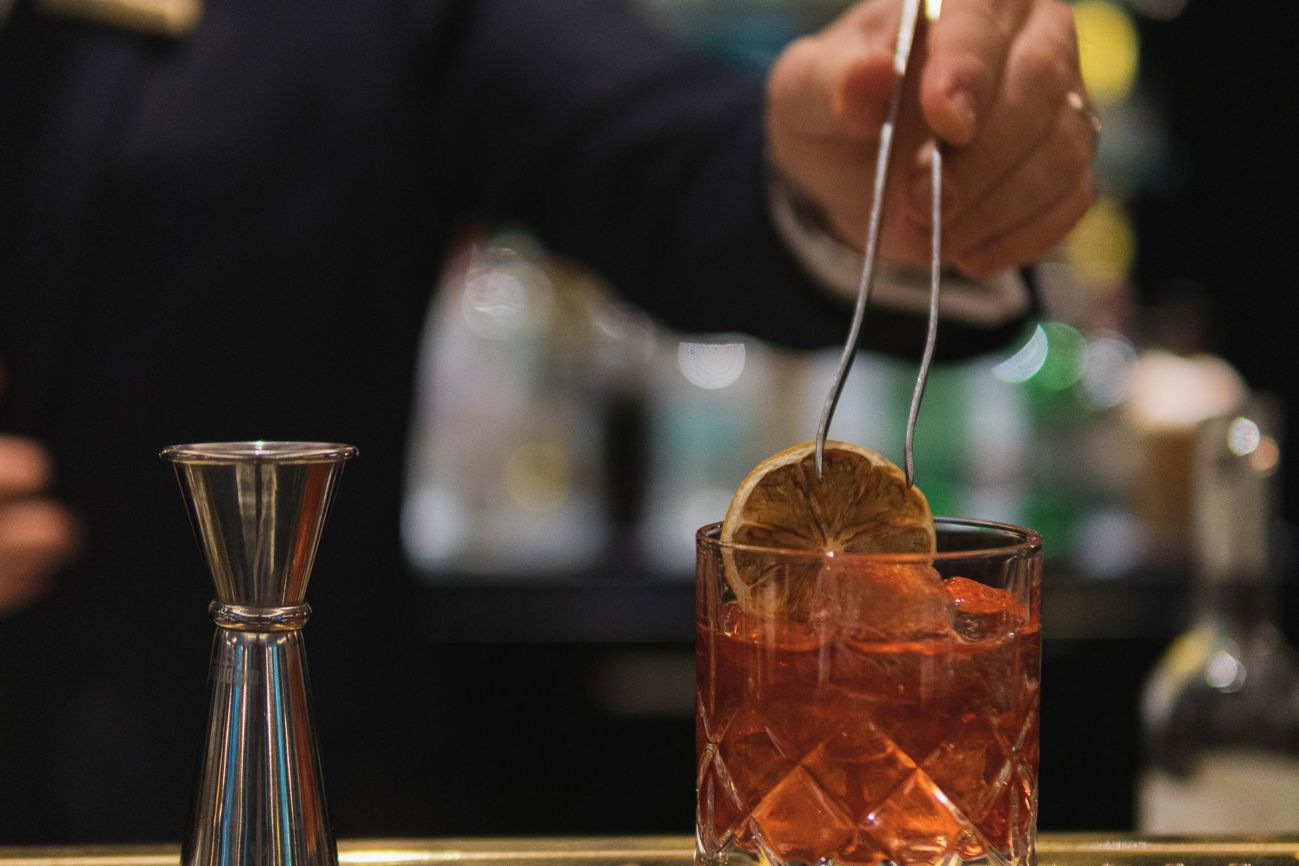 adding a fruit garnish to a cocktail