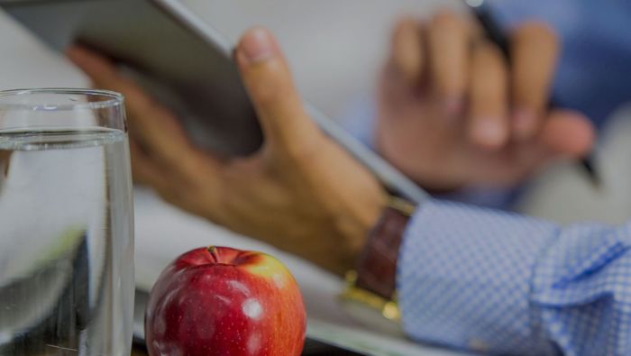 business man with apple and glass of water
