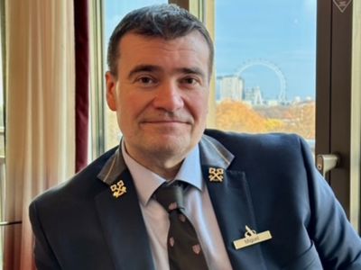 Miguel, head concierge in a room with London view out of the window