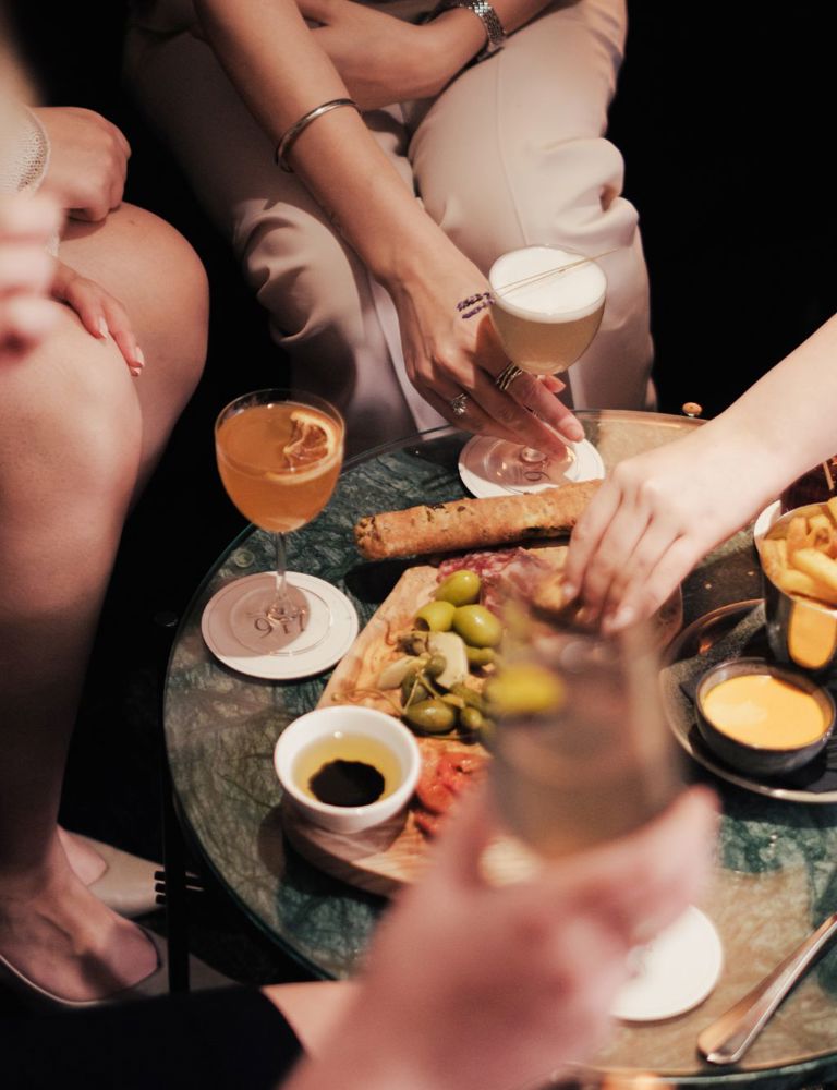 Group of people sharing food with drinks