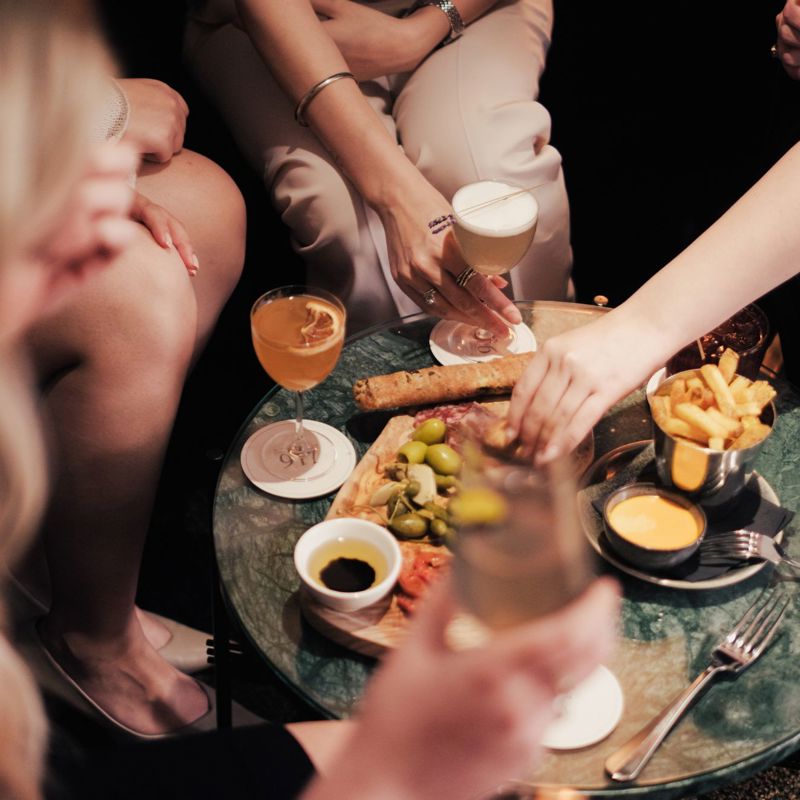 Group of people sharing food with drinks