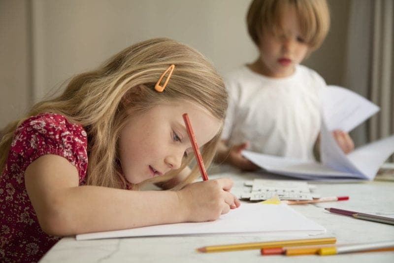 Children colouring with crayons in The Athenaeum's hotel family rooms in London