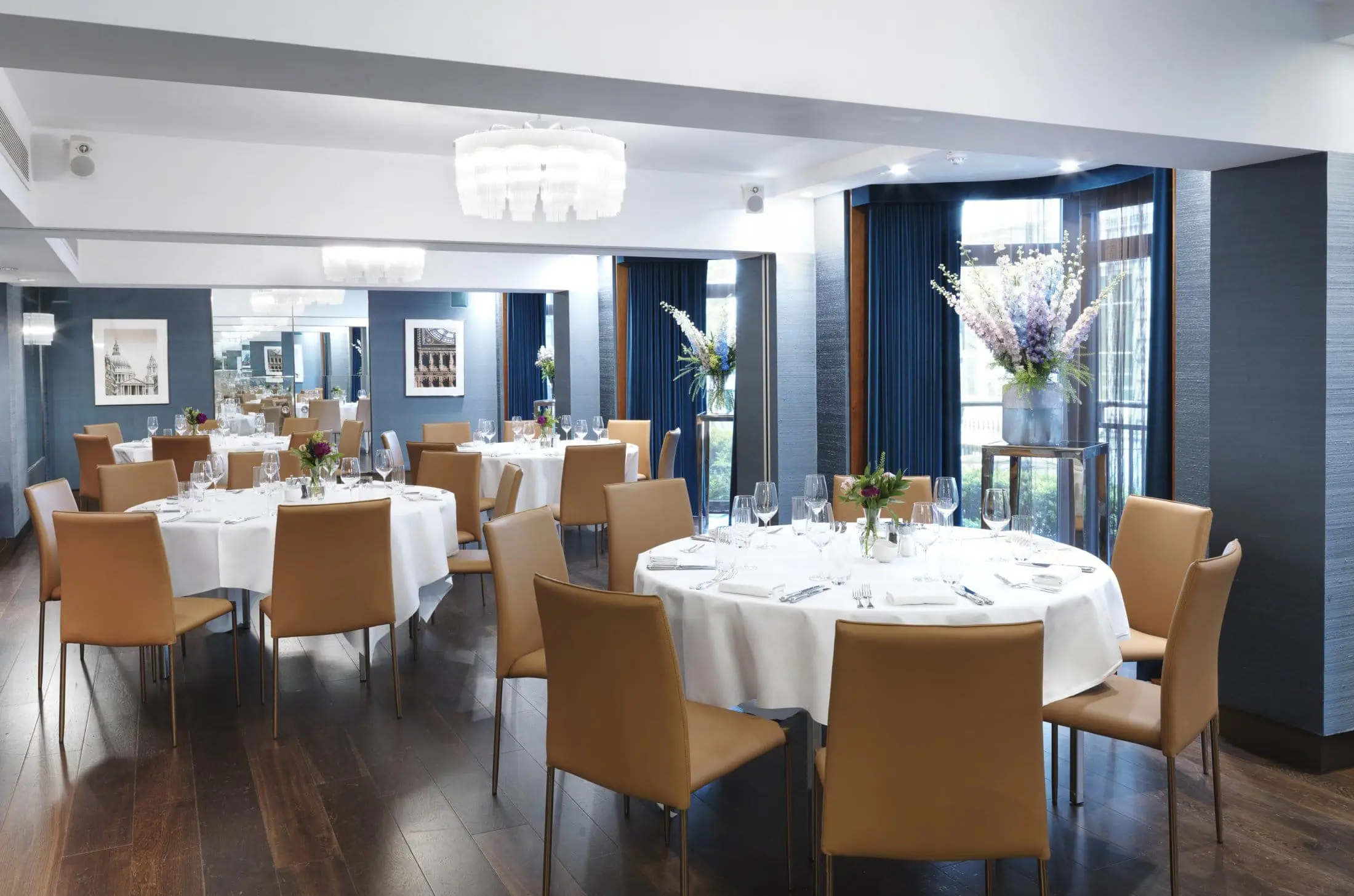 A Private Dining room in London at The Athenaeum. The room is full of multiple chairs and tables.