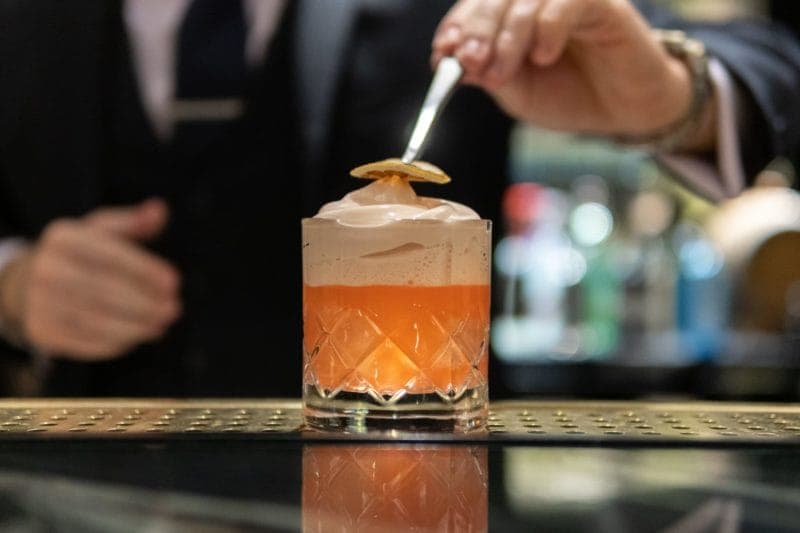 An image of a waiter making a drink at a Cocktail Masterclass in London