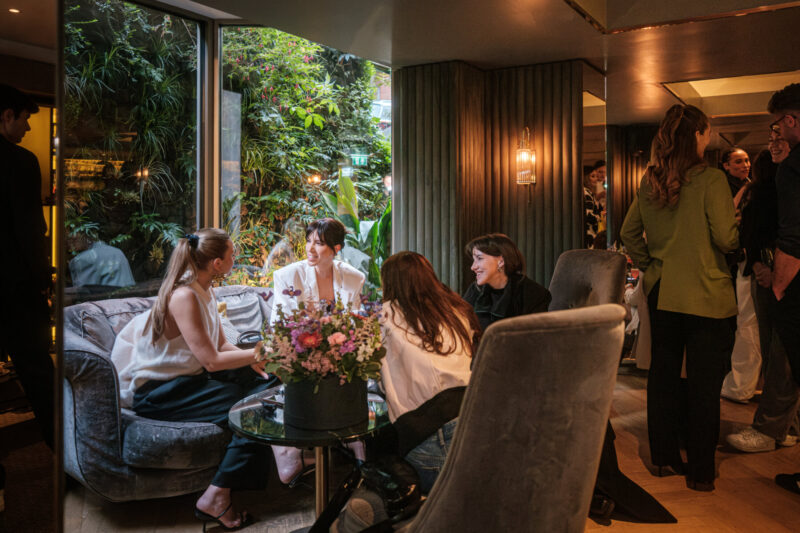 Friends chatting and enjoying drinks at a cocktail bar in Central London called 
