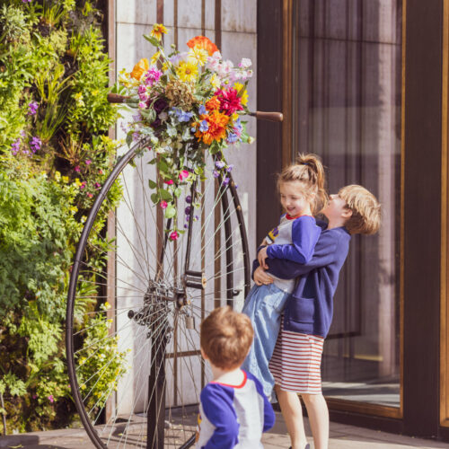 Three kids playing outside The Athenaeum, a luxury family hotel London